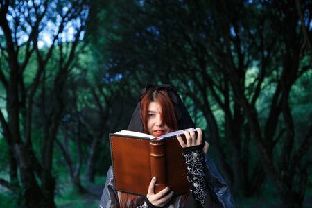 Portrait of witch in black hoodの写真素材