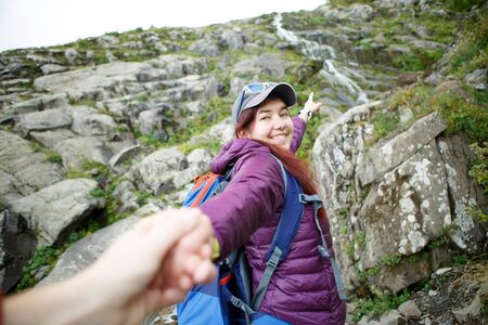 Image of tourist girl pulling man by handの写真素材