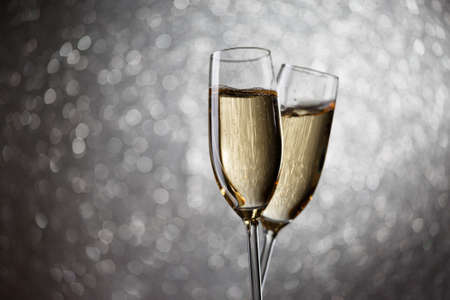 Festive image of two wine glasses with sparkling champagneの写真素材