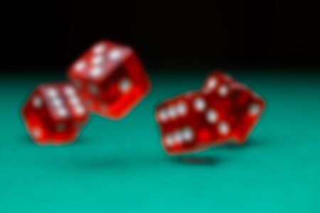 Picture of dice falling on green tableの写真素材