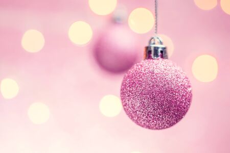 Picture of two New Years pink balls on pink background with spots.の写真素材