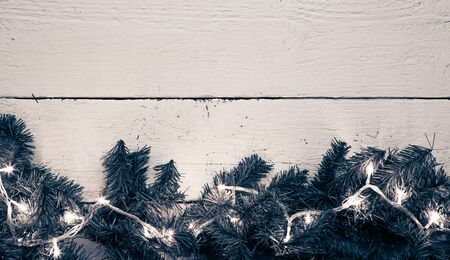 Christmas lighted fir tree over wooden background with copyspaceの写真素材