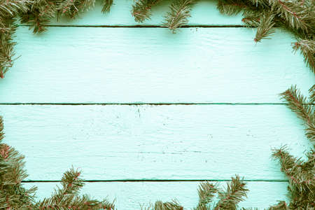 New year and christmas light blue wooden background with evergre