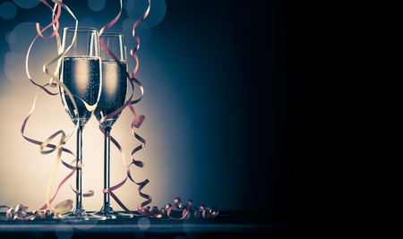 Two glasses with sparkling champagne and decorative ribbonsの写真素材