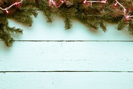 Christmas, new year wooden background with fir tree and garland