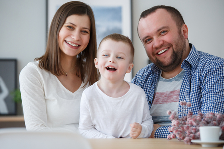 Image of happy family with her son in roomの写真素材