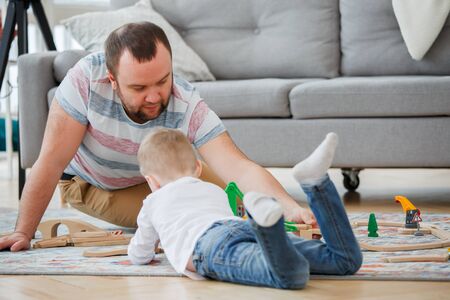 Photo of father and son playing in toy roadの写真素材