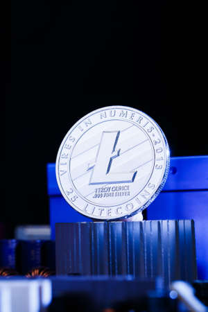 Picture of crypto currency litecoin and processor on blue backgroundの写真素材
