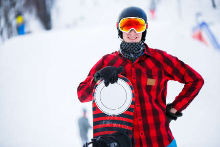 Image of standing athlete with snowboard in winter parkの写真素材