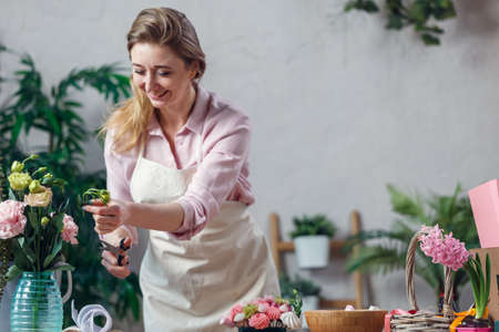 Professional florist working in flower shop.の写真素材