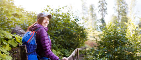 Photo of girl with backpack in forest