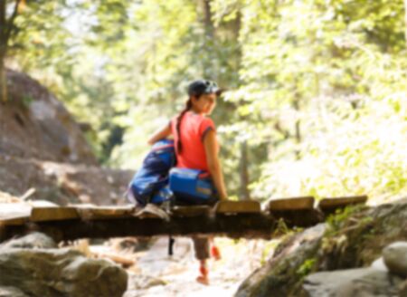 Blurred photo from back of girl with backpackの写真素材