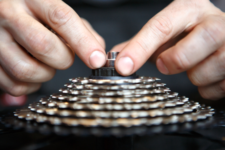 Picture of man repairing bicycle gear.の写真素材