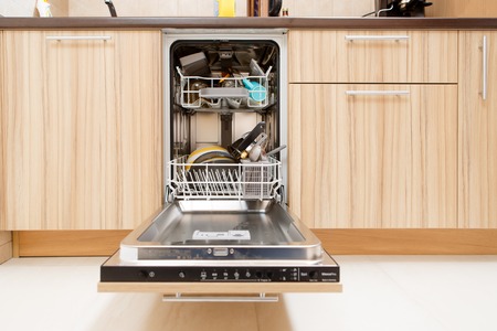 Image of open dishwasher with dirty dishesの写真素材