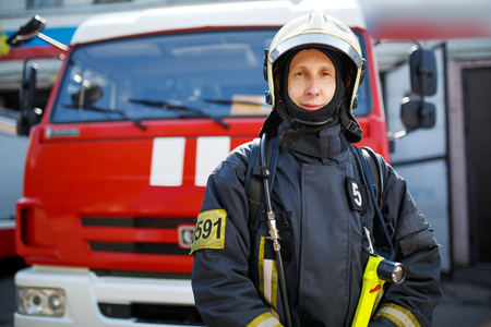 Photo of fireman in front of red carの写真素材