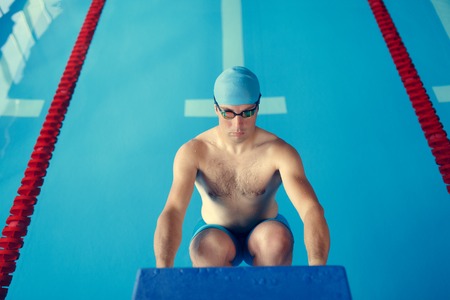 Image of sportsman in blue cap at side in poolの写真素材
