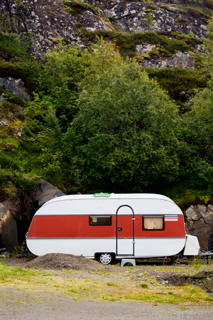 Motorhome on background of mountains of rocks with trees