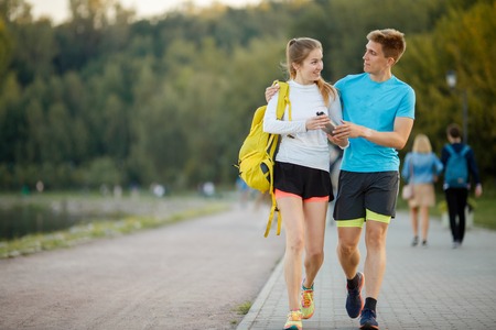 Image of hugging sports women and men going in parkの写真素材