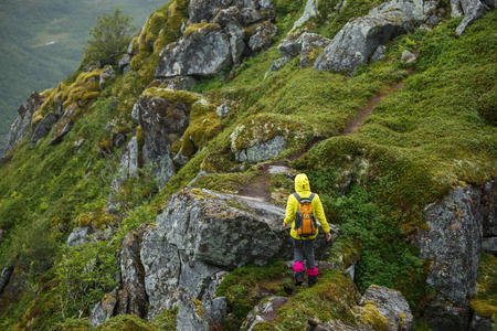 Sports woman in jacket on background of mountain landscapeの写真素材