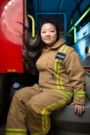 Image of woman firefighter on background of fire truckの写真素材