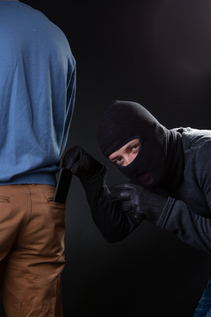 Thief steals man from wallet pocketの写真素材