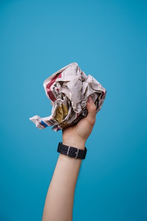 hand with crumpled newspaper.の写真素材