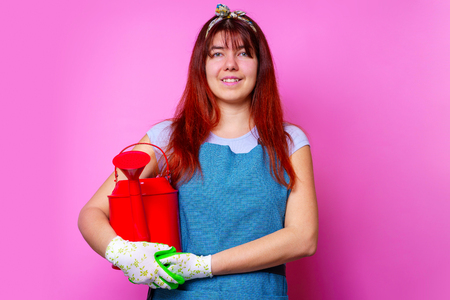 Image of happy florist brunette woman with watering can in handの写真素材