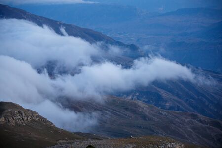 Image of foggy mountain area at sunset in summer