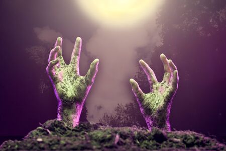 Photo of two zombie hands sticking out of grave.の写真素材