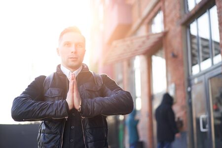 Brunet on walk in city against backdrop of buildings at day.の写真素材