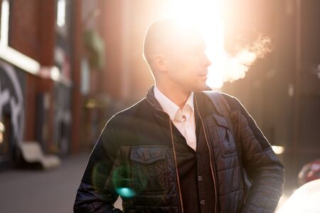 Male looking at side walking in city during day, Sunshine effect.