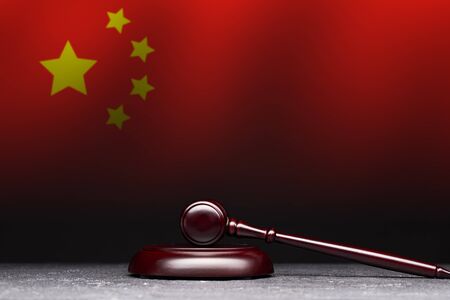 Judges gavel on background of flag of China.の写真素材