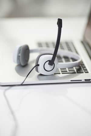 Close-up of headphones with black microphone on bokeh background.の写真素材