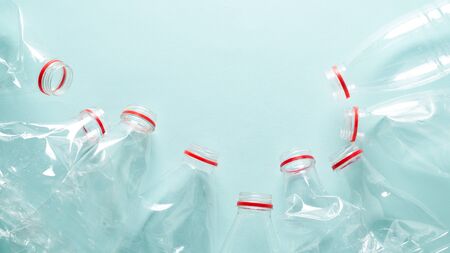 Empty crumpled plastic bottles at blue background