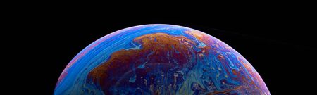 Soap bubble isolated on black. Space, planet, universe concept