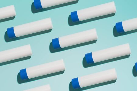 Hygienic lipstick on empty blue backgroundの写真素材