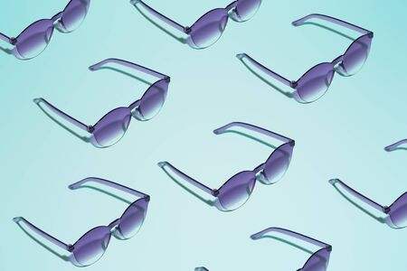 Black sunglasses on empty blue backgroundの写真素材