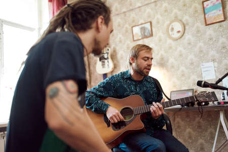 Male musicians rehearsing at home