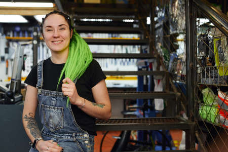 Smiling woman sitting on stairway in shop