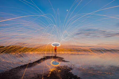 Amazing steel wool coast the sea on the beach in sunrise time.の写真素材