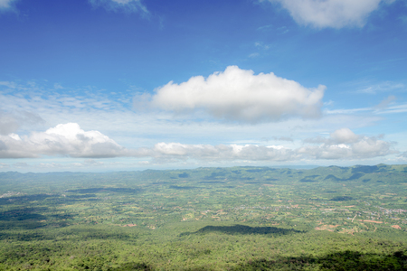 Green meadow and hill under blue sky with clouds in  summerの写真素材