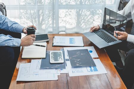 Businessman investor on meeting having planning and analyzing of partner cooperation in investment trading marketing project and pointing on the data presented and deal on a stock exchange to profit.の写真素材