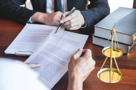 Professional male lawyer or counselor discussing negotiation legal case with client meeting with document contract in office, law and justice, attorney, lawsuit concept.の写真素材