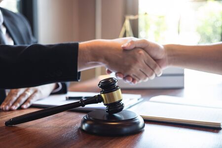 Handshake after good deal negotiation cooperation, Professional male lawyer or counselor and client...