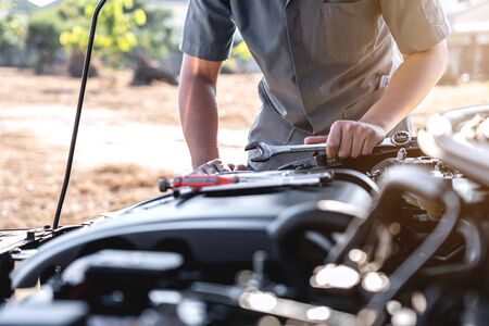 Technician hands of car mechanic in doing auto repair service and maintenance worker repairing...