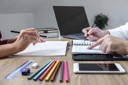 Teaching helping and study course, Team of young teacher or tutor helps students to learning in...