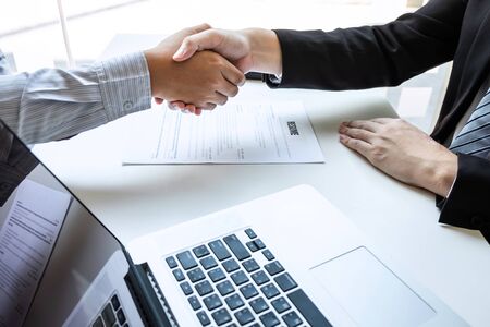 Good deal of interview, Business people and recruiter shaking hands greeting or get acquainted of conducting a job interview while sitting at the working meeting in office.の写真素材