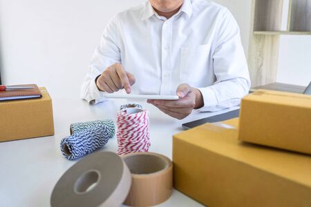 Young entrepreneur business owner work at home, small business startup receive order client and take...