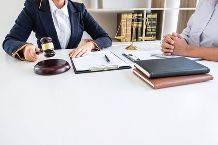 Professional female lawyer or counselor discussing negotiation legal case with client meeting with document contract in office, law and justice, attorney, lawsuit concept.の写真素材