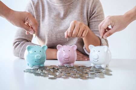 Image of hands putting coins into piggy bank planning growing saving to strategy with money box for...